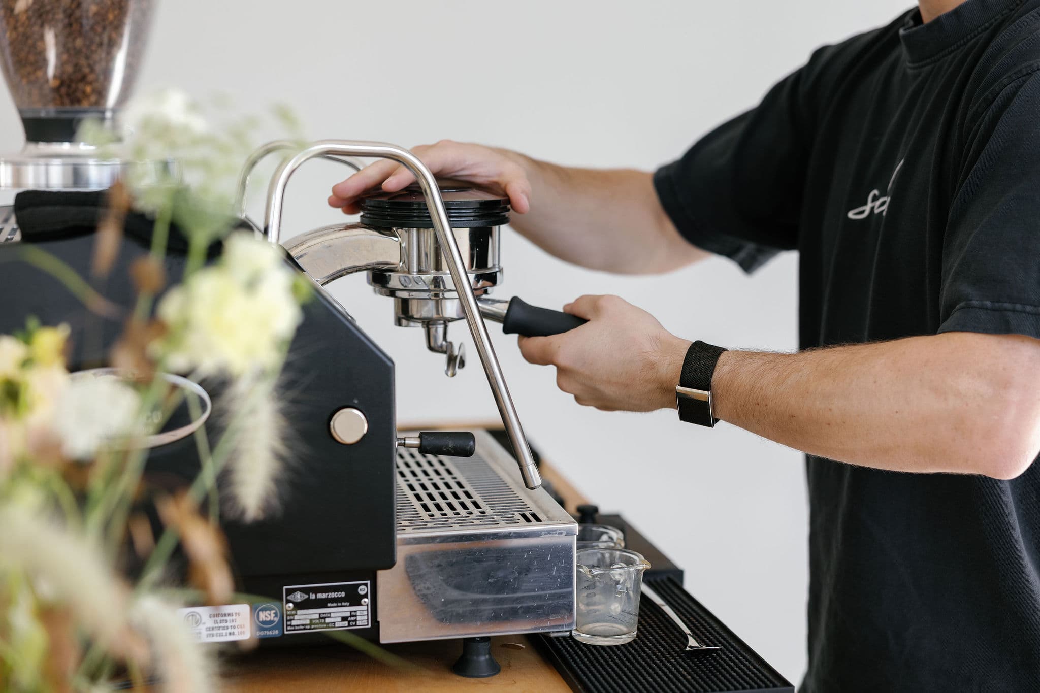 Barista locking portafilter into espresso machine