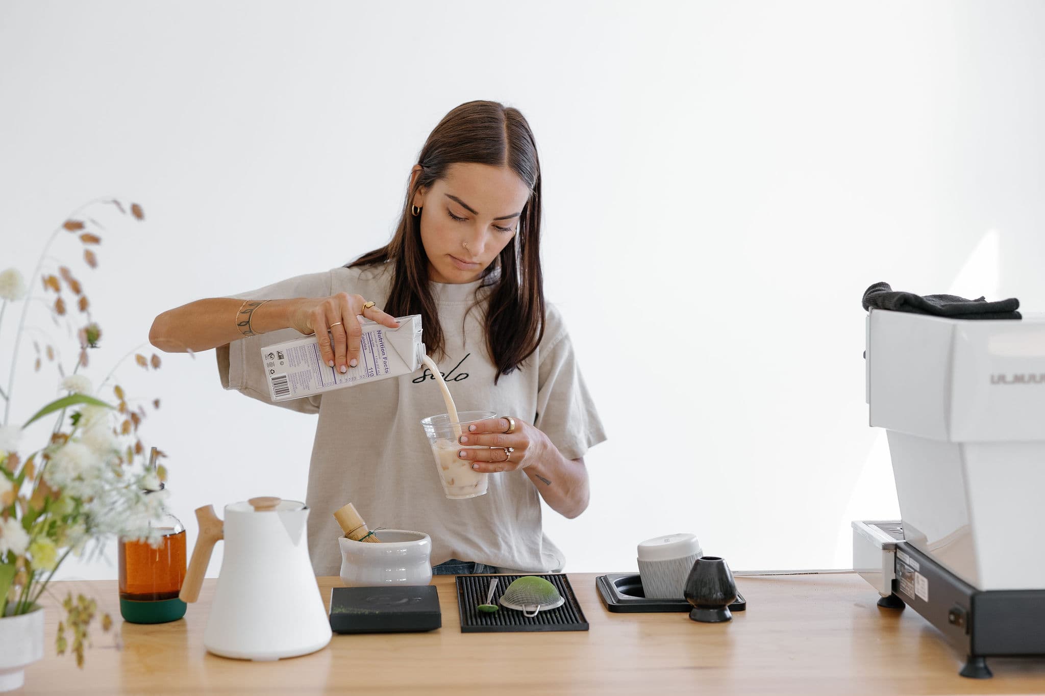 Barista pouring milk